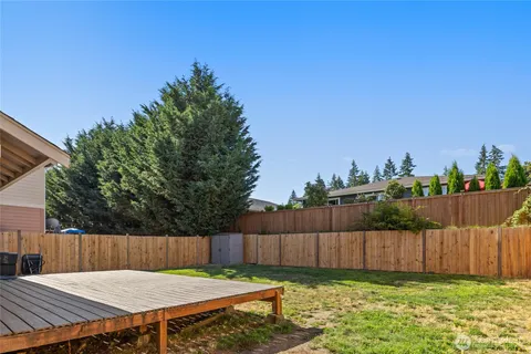 a view of a backyard with a table and chairs