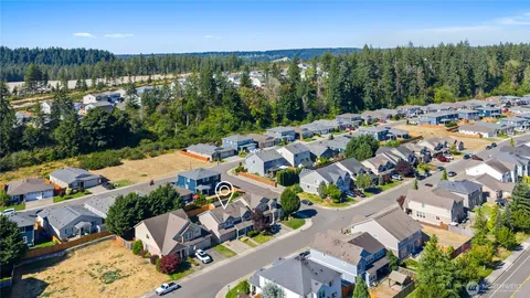 an aerial view of residential houses with outdoor space and river