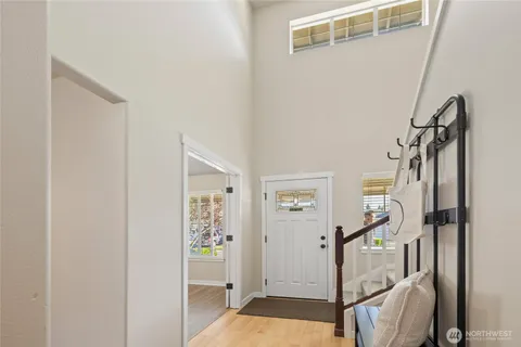 a view of entryway with wooden floor and stairs