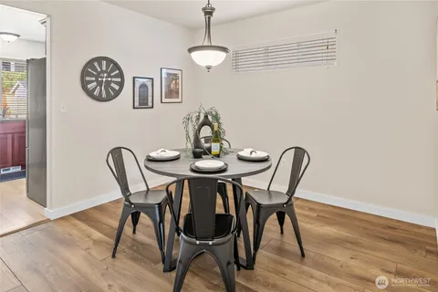 a view of a dining room with furniture wooden floor and a chandelier