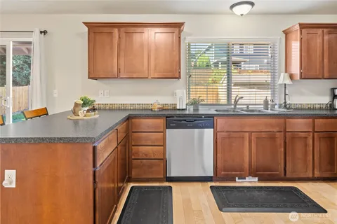 a kitchen with a sink stove and cabinets
