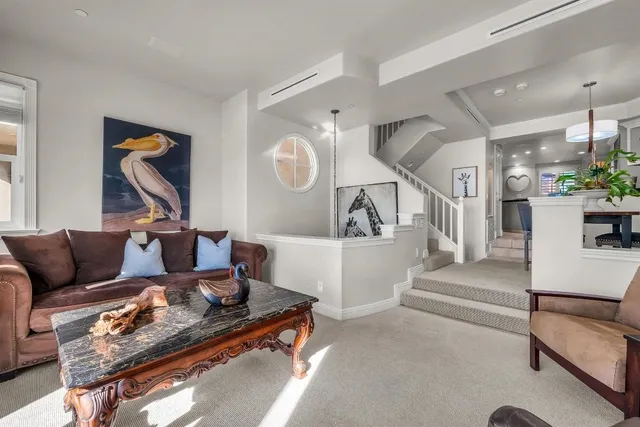 a living room with furniture and a floor to ceiling window