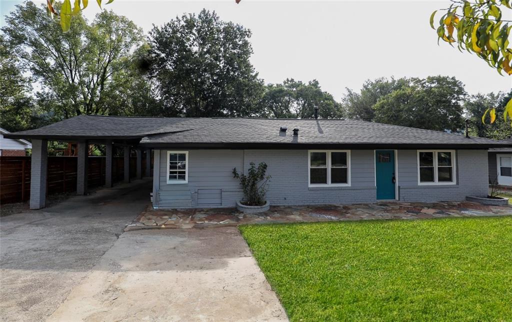 a front view of a house with a garden and yard
