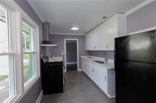 a kitchen with a refrigerator and a stove