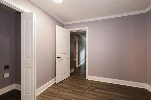 a view of hallway with wooden floor