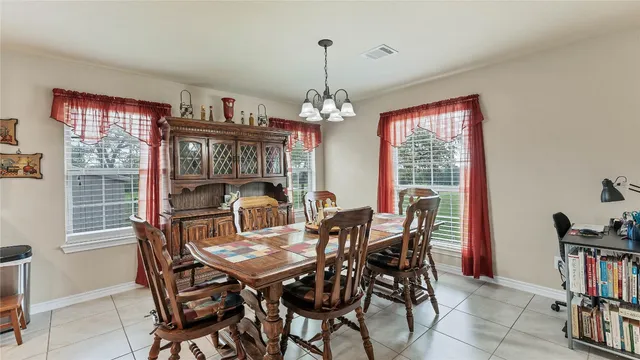 a view of a dining room with furniture and a window