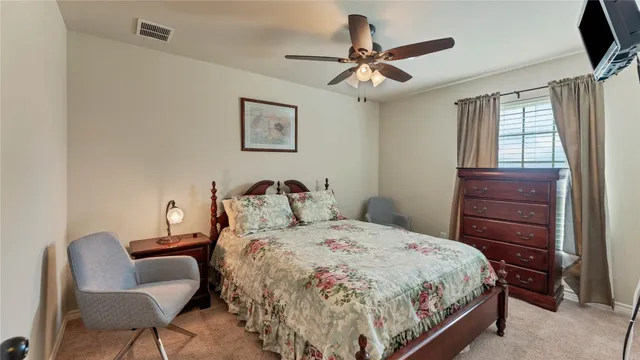 a bedroom with a bed and chair