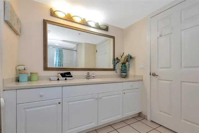 a bathroom with a double vanity sink and a mirror