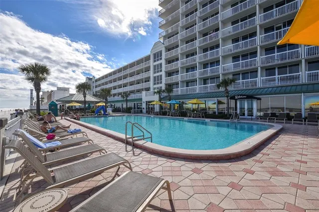 a view of a patio with table and chairs and potted plants