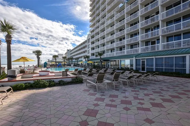 a view of hall with an entryway and wooden floor