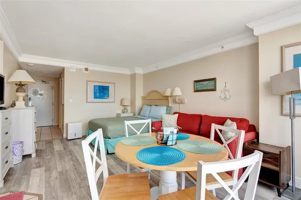 a dining room with furniture and wooden floor