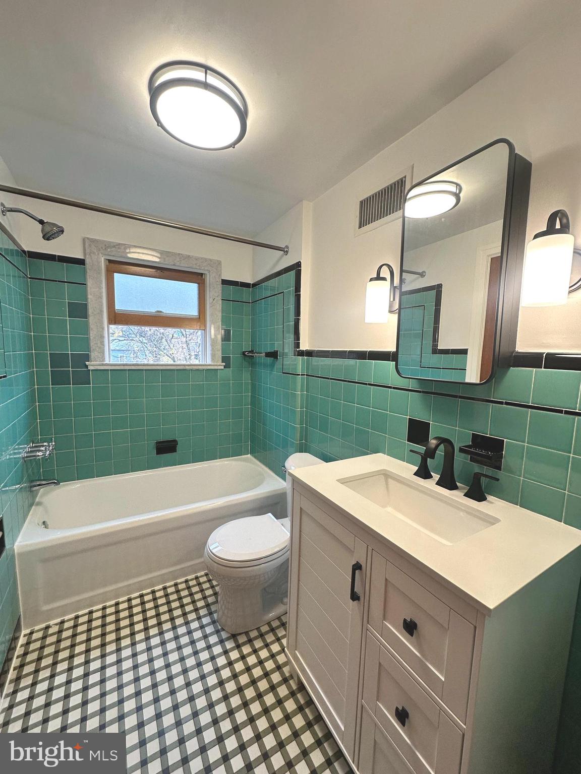 1009 Parkside Avenue, Unit 2 Ewing, NJ 08618 - Photo 13 of 23 a bathroom with a sink a toilet a mirror and bathtub