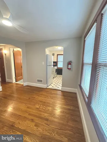 a view of a living room with hardwood floor and a large window