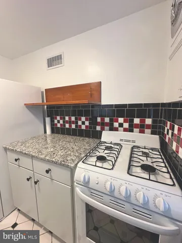 a kitchen with a stove and a microwave