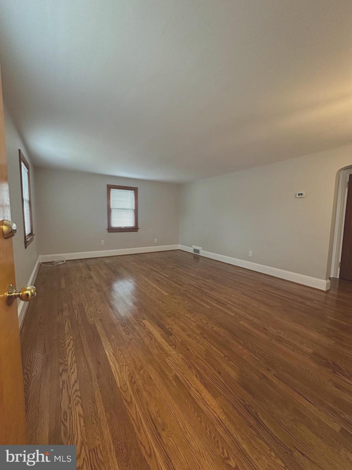 1009 Parkside Avenue, Unit 2 Ewing, NJ 08618 - Photo 5 of 23 an empty room with wooden floor and windows