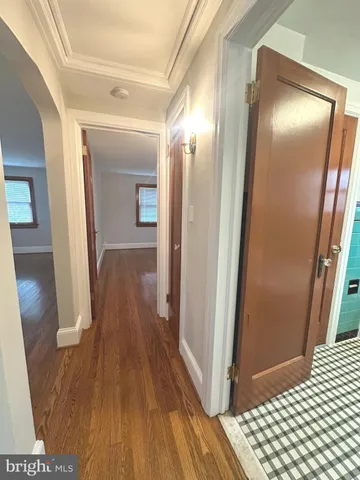 a view of hallway with wooden floor