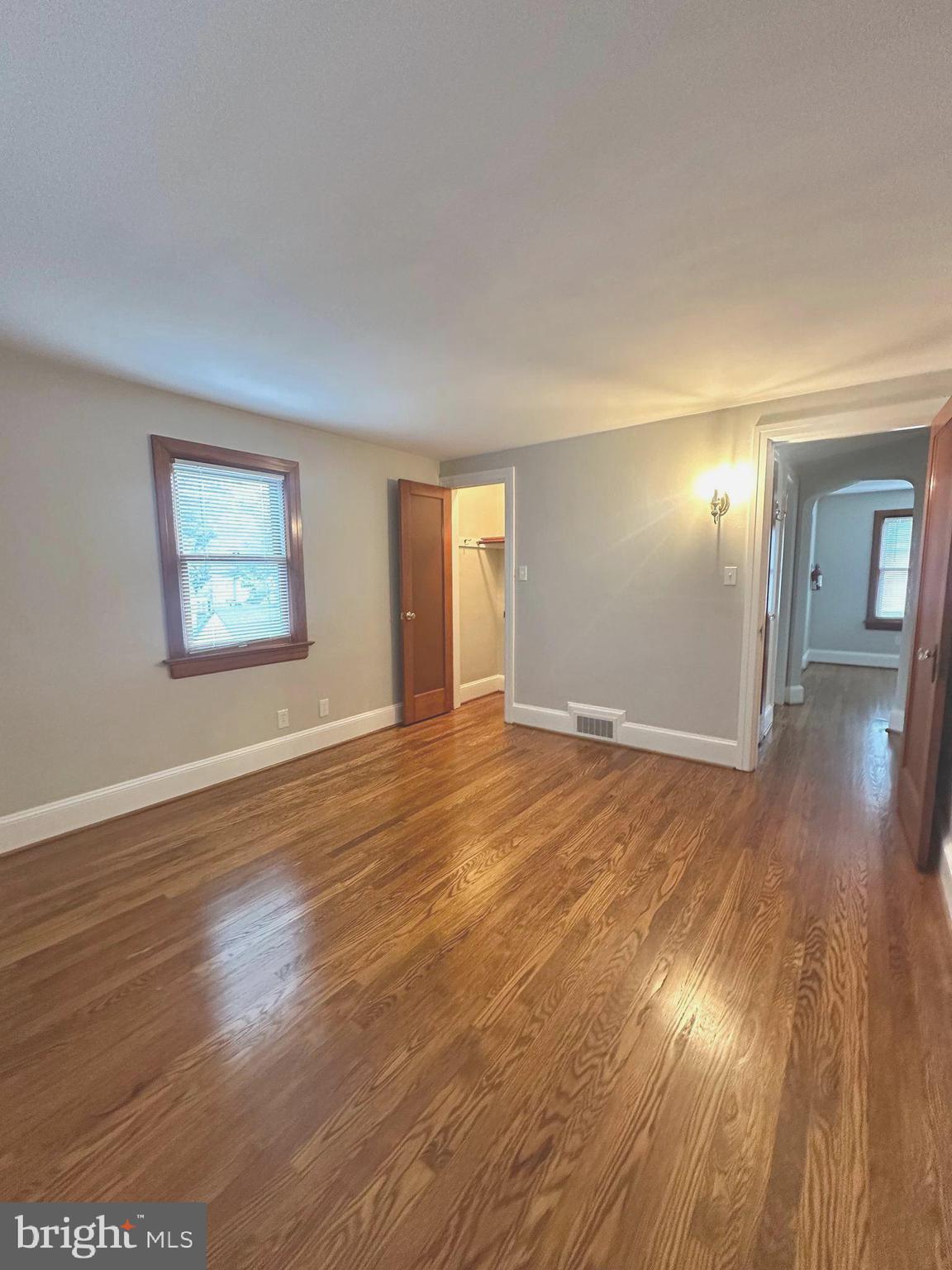 1009 Parkside Avenue, Unit 2 Ewing, NJ 08618 - Photo 9 of 23 an empty room with wooden floor and windows