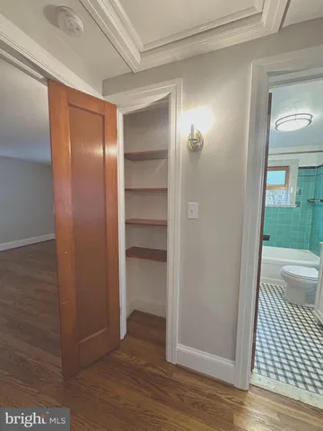 a view of a room with wooden floor