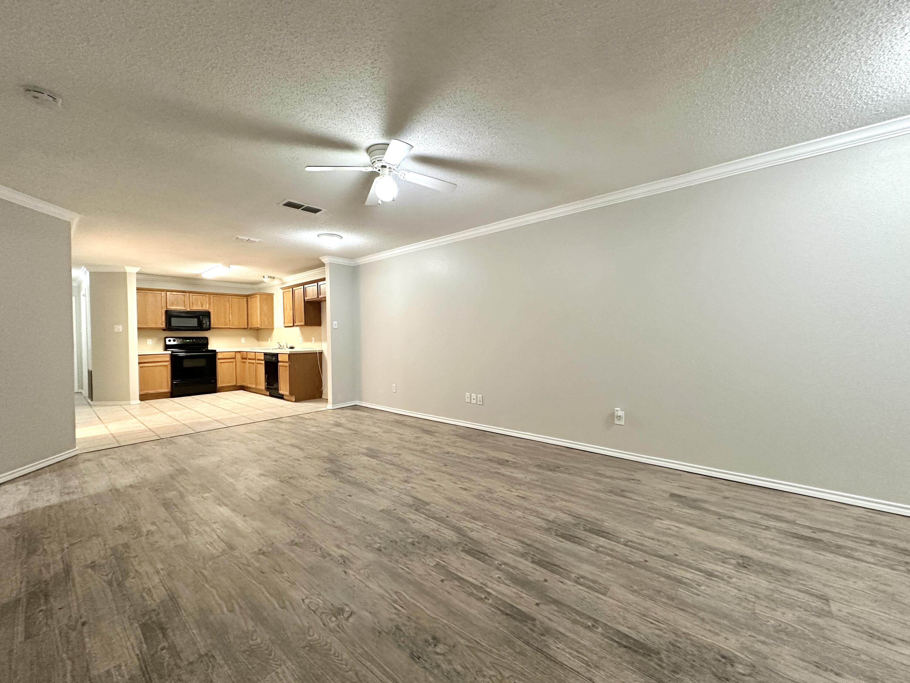 615 North Elkhart Avenue Lubbock, TX 79416 - Photo 4 of 15 a view of a big room with wooden floor and windows