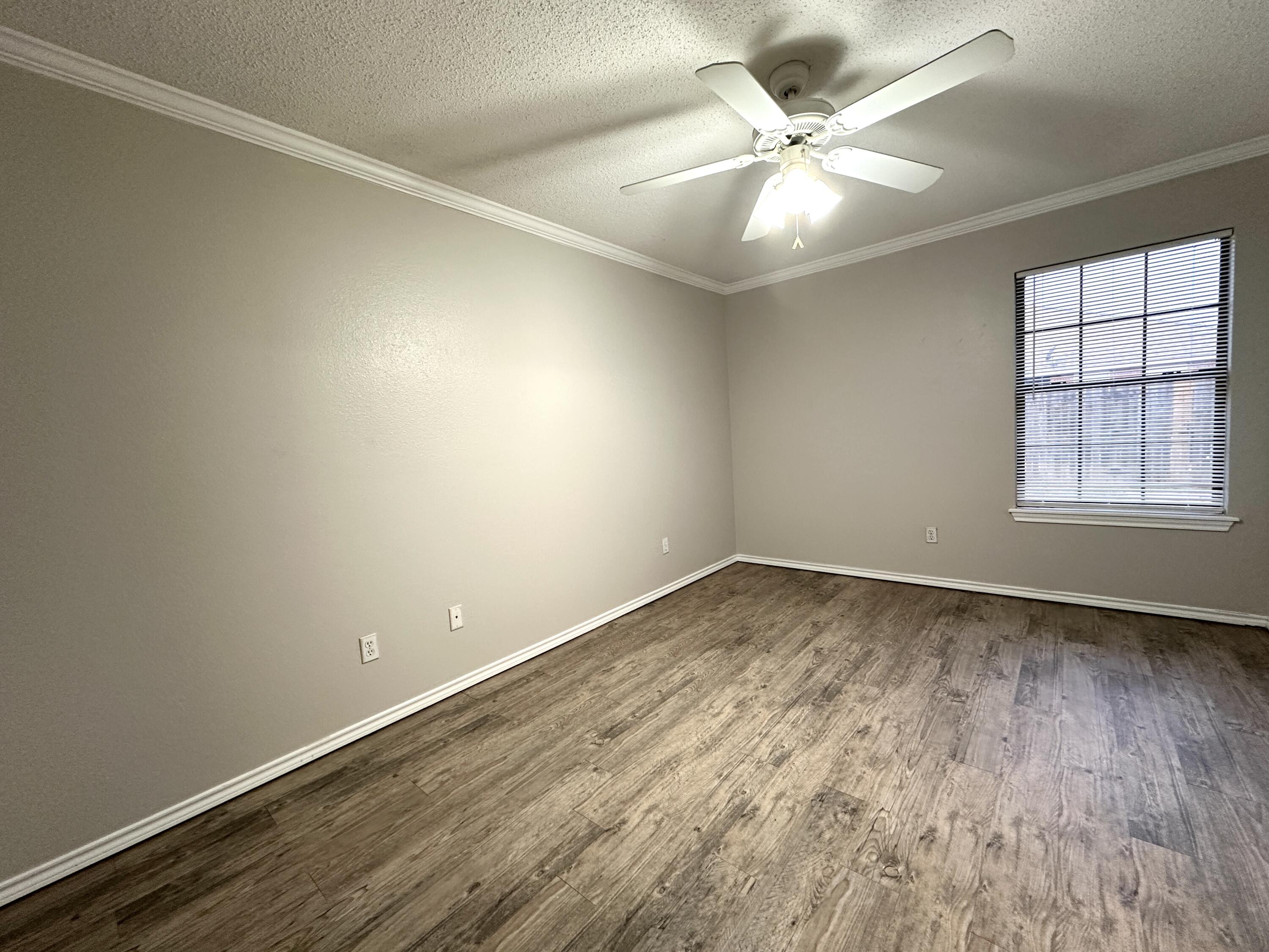 615 North Elkhart Avenue Lubbock, TX 79416 - Photo 10 of 15 wooden floor in an empty room with a window