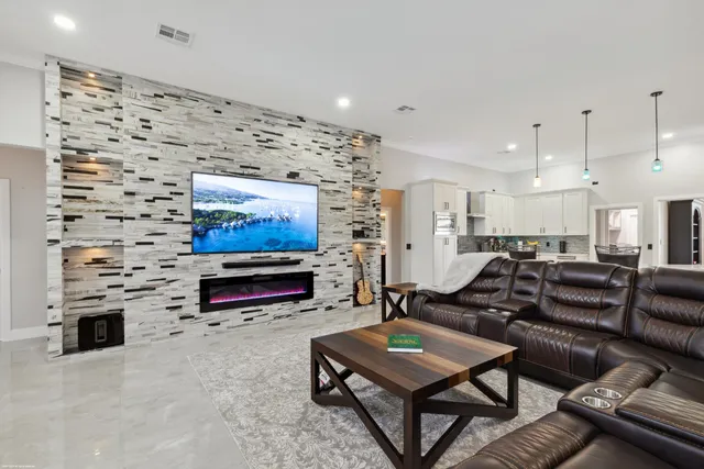 a kitchen with stainless steel appliances granite countertop a sink a stove and cabinets