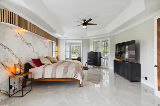 a bedroom with a bed and glass window