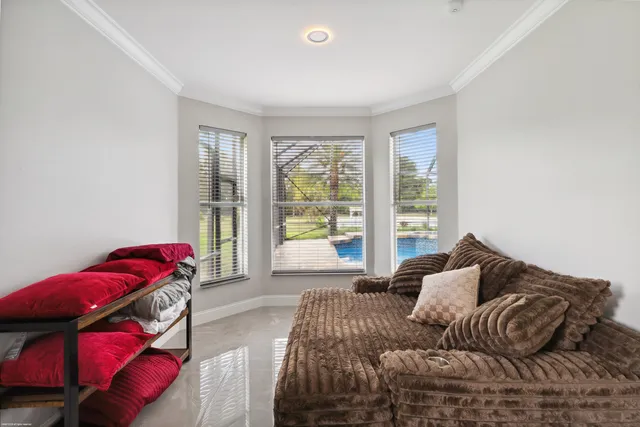 a bedroom with a bed a couch and a window