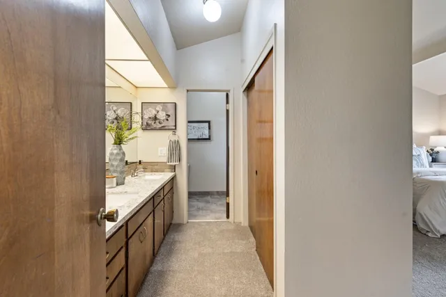 a bathroom with a granite countertop sink a mirror and a bathtub
