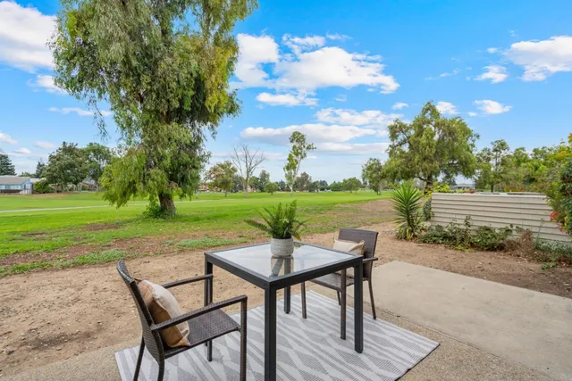 a view of a table and chairs in the garden
