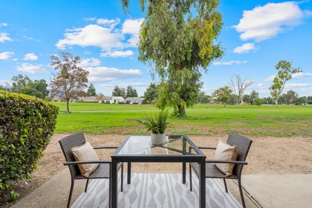 a patio with table and chairs