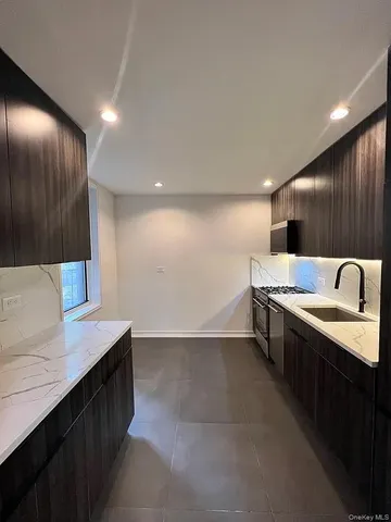a kitchen with a sink and a refrigerator