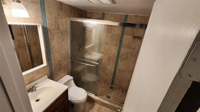 a bathroom with a shower and toilet