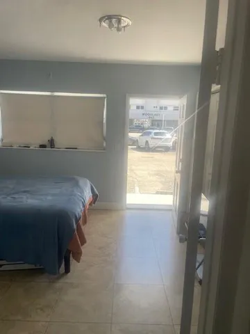 a bed sitting in a bedroom next to a window