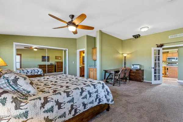 a bedroom with a bed and ceiling fan