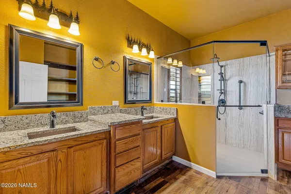 a bathroom with a double vanity sink and mirror