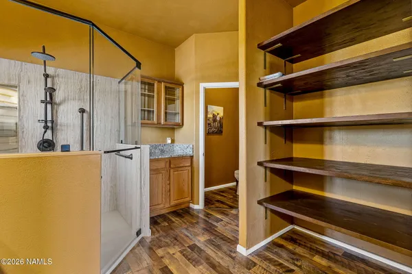a view of walk in closet with empty racks