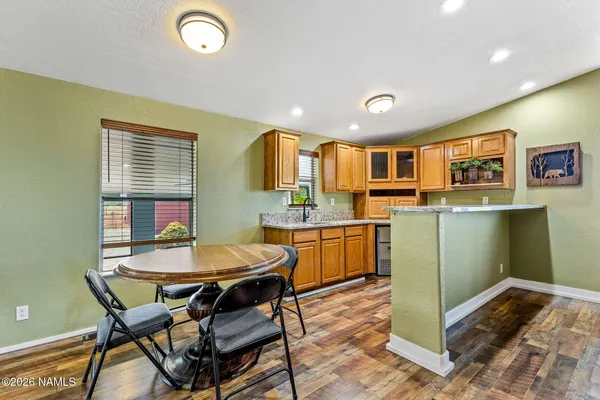 a kitchen with a table and chairs in it