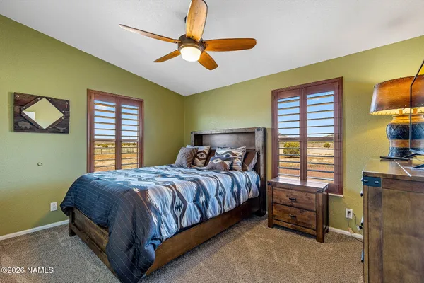 a bedroom with a bed next to a window