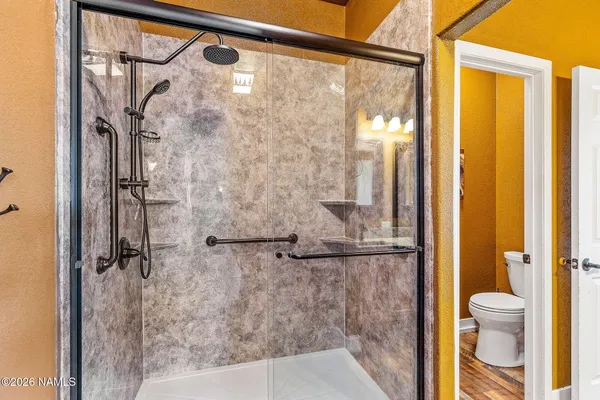a bathroom with a glass shower door