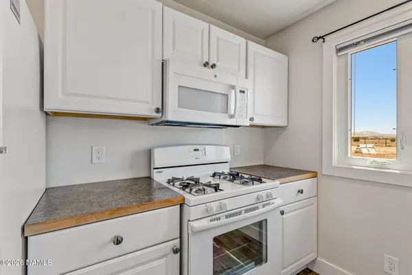 a stove top oven sitting inside of a kitchen