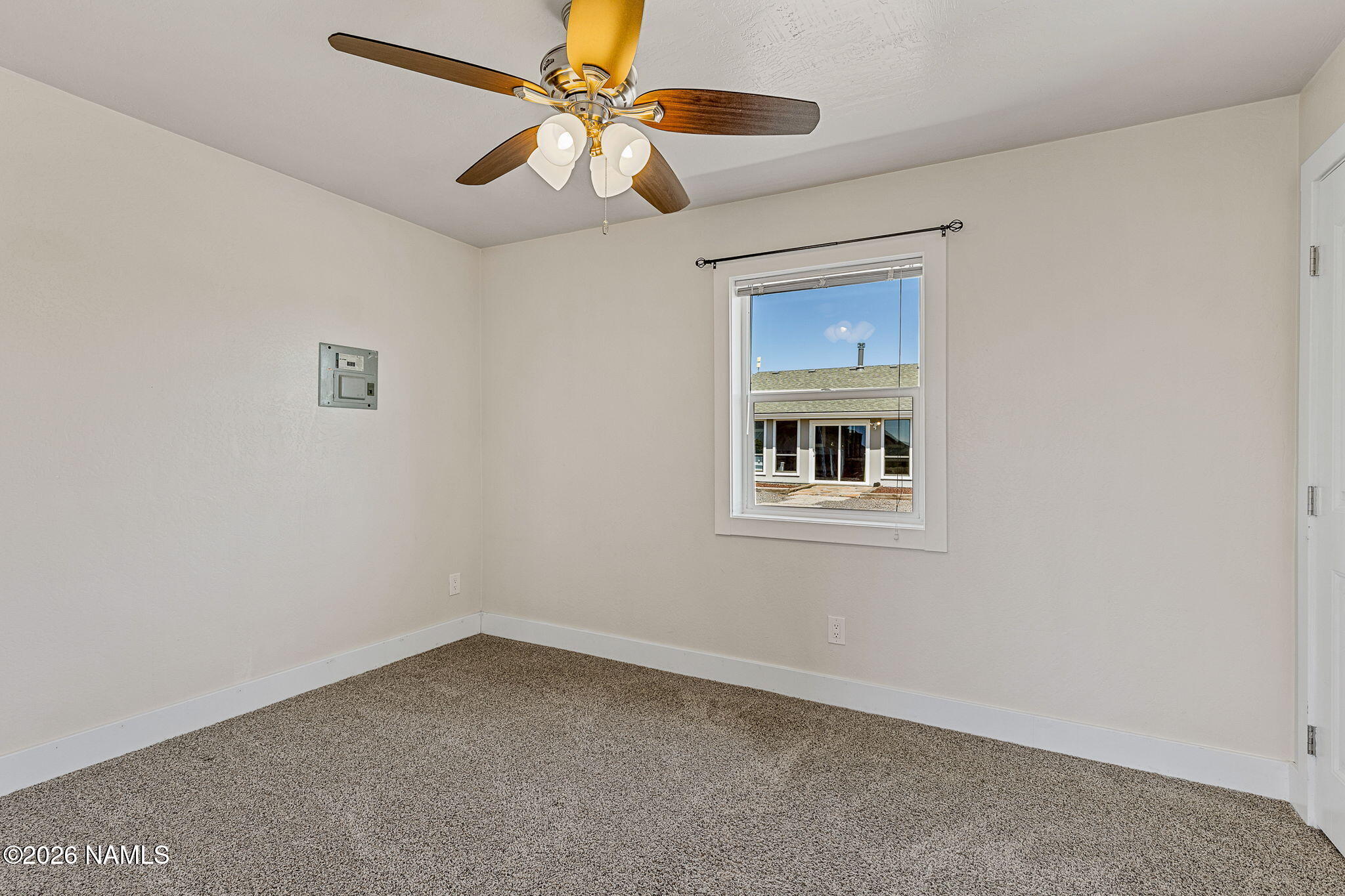 2318 Hoctor Road Williams, AZ 86046 - Photo 32 of 36 an empty room with a window and a fan