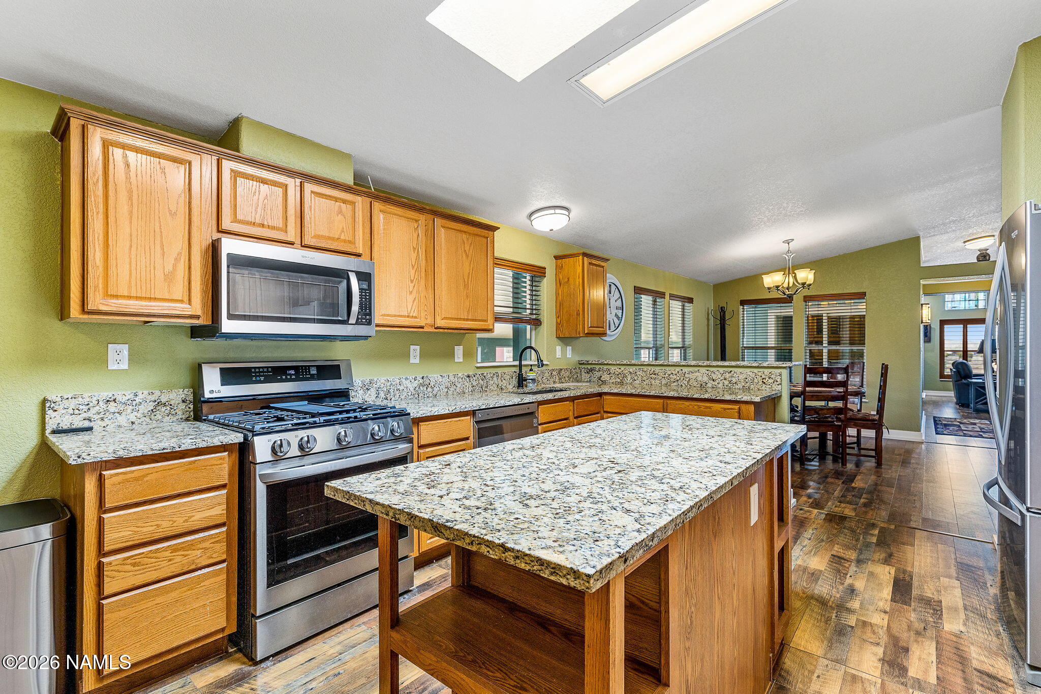 2318 Hoctor Road Williams, AZ 86046 - Photo 8 of 36 a kitchen with a stove a sink and a wooden cabinets