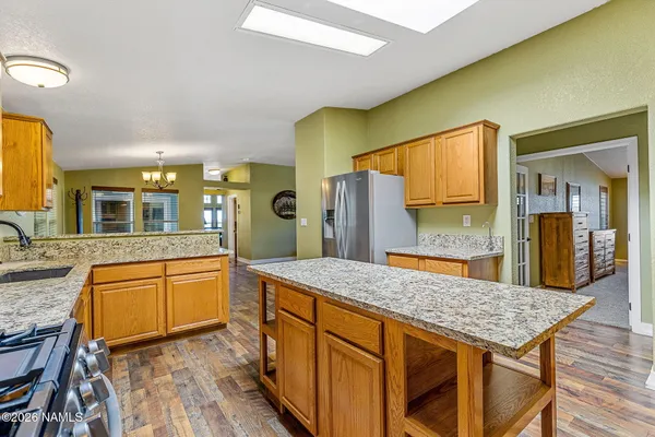 a spacious bathroom with a granite countertop sink and a large mirror