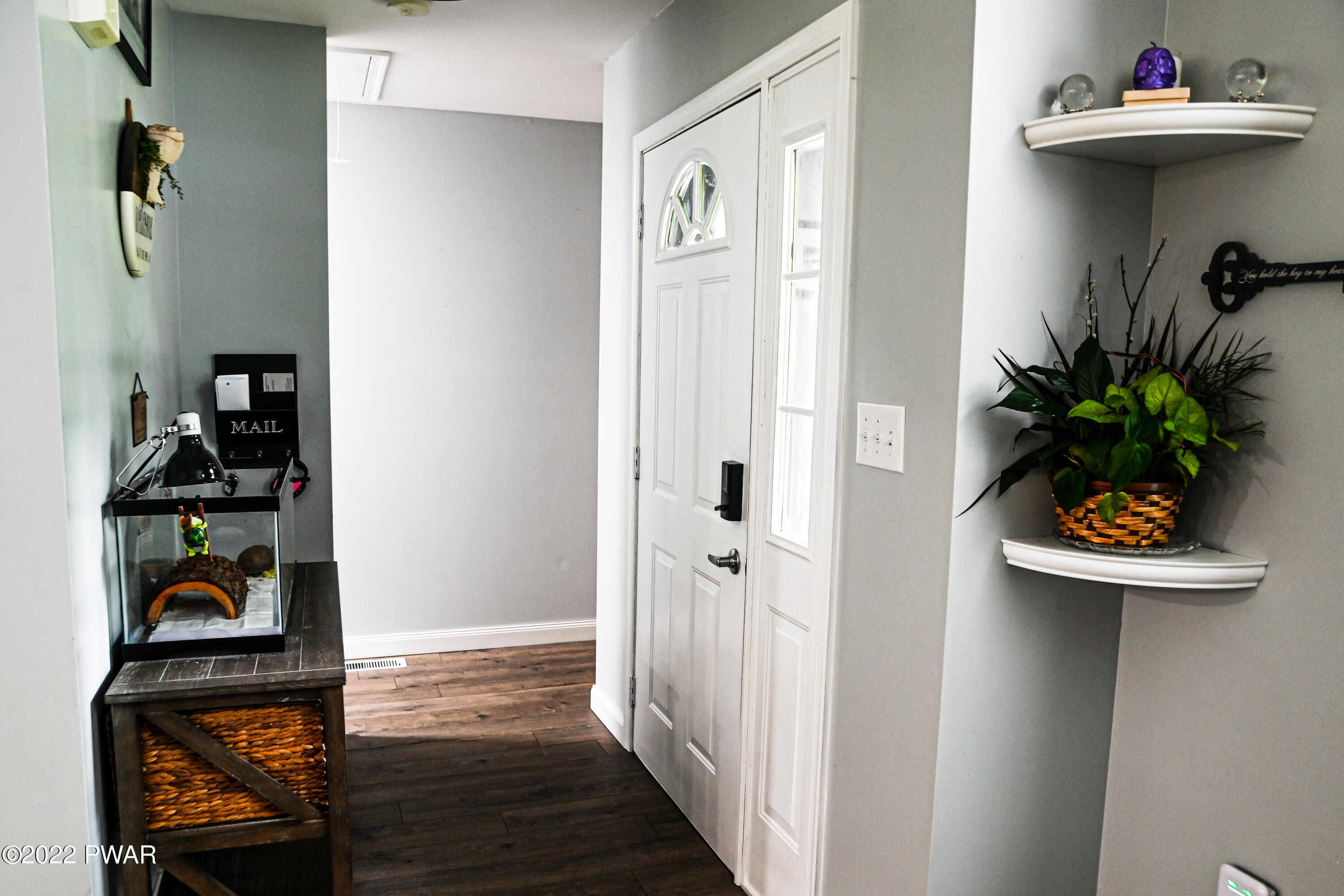 233 Bromley Road Henryville, PA 18332 - Photo 5 of 22 a view of a hallway to room with wooden floor and shoes