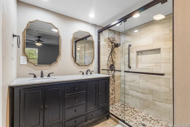 a bathroom with a double vanity sink and a mirror