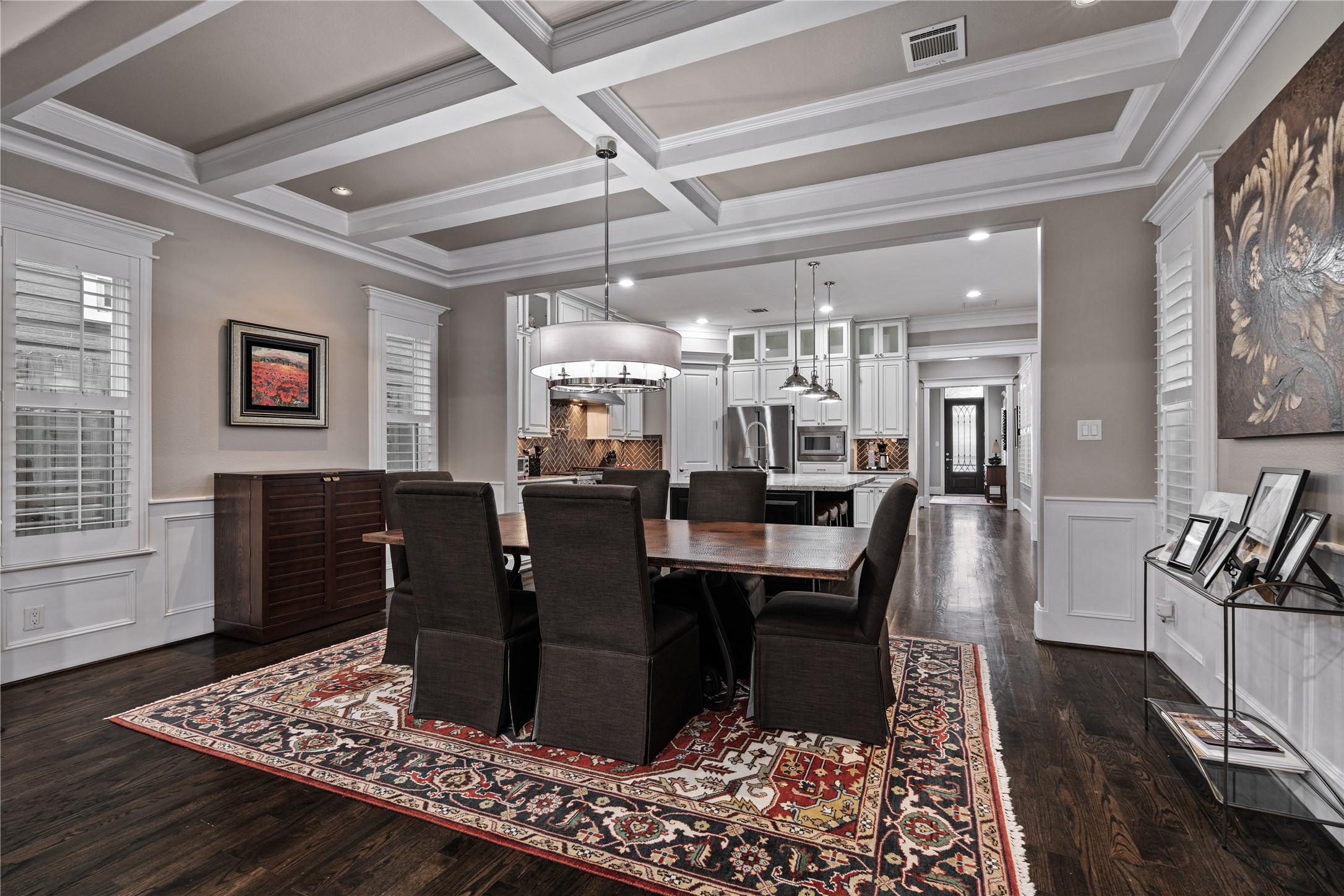 422 West 26th Street Houston, TX 77008 - Photo 14 of 39 Centered over the dining area is a designer Mitchell Gold and Bob Williams chandelier (2025), which stays with the home to elevate the space.