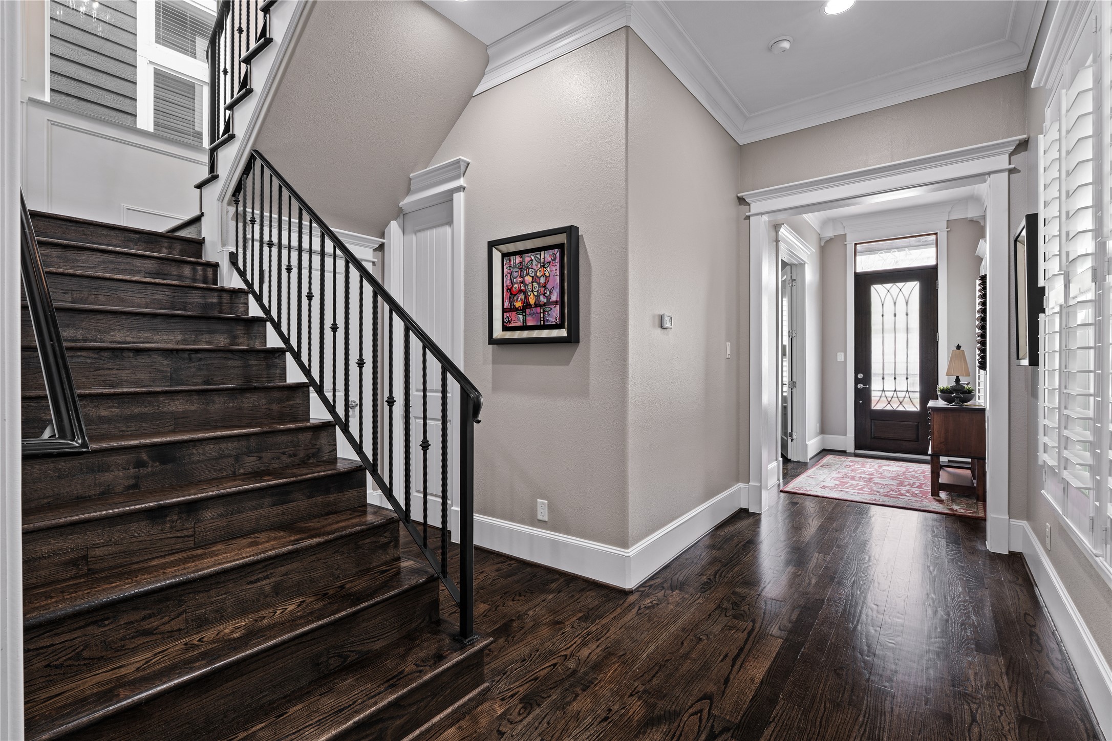 422 West 26th Street Houston, TX 77008 - Photo 17 of 39 The elegant wood staircase with wrought-iron spindles leads to a secondary landing area, accented by custom trim work and rich hardwood floors.
