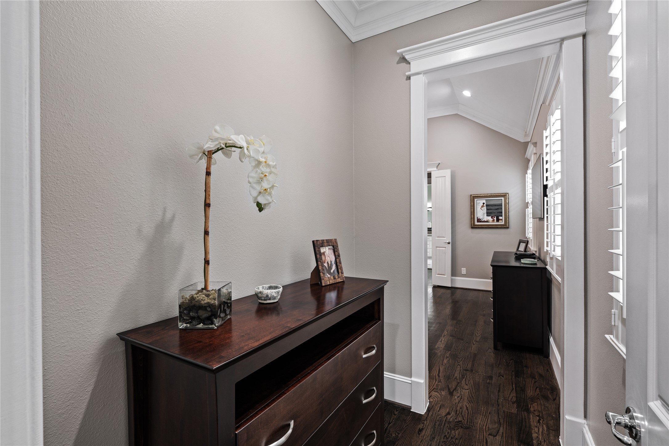 422 West 26th Street Houston, TX 77008 - Photo 18 of 39 A quiet hallway leads to the primary retreat, featuring hardwood floors and integrated pathway lighting for convenience at night.