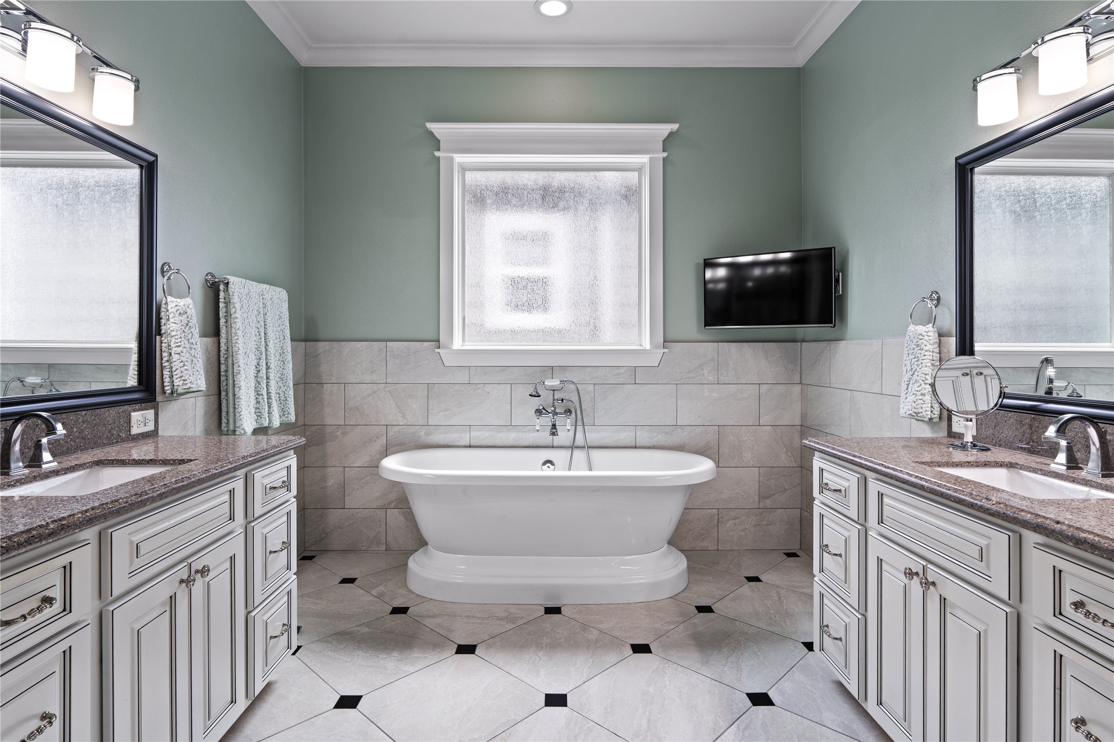 422 West 26th Street Houston, TX 77008 - Photo 21 of 39 The primary bathroom serves as a true sanctuary, featuring a freestanding soaking tub centered under a privacy-glass window.