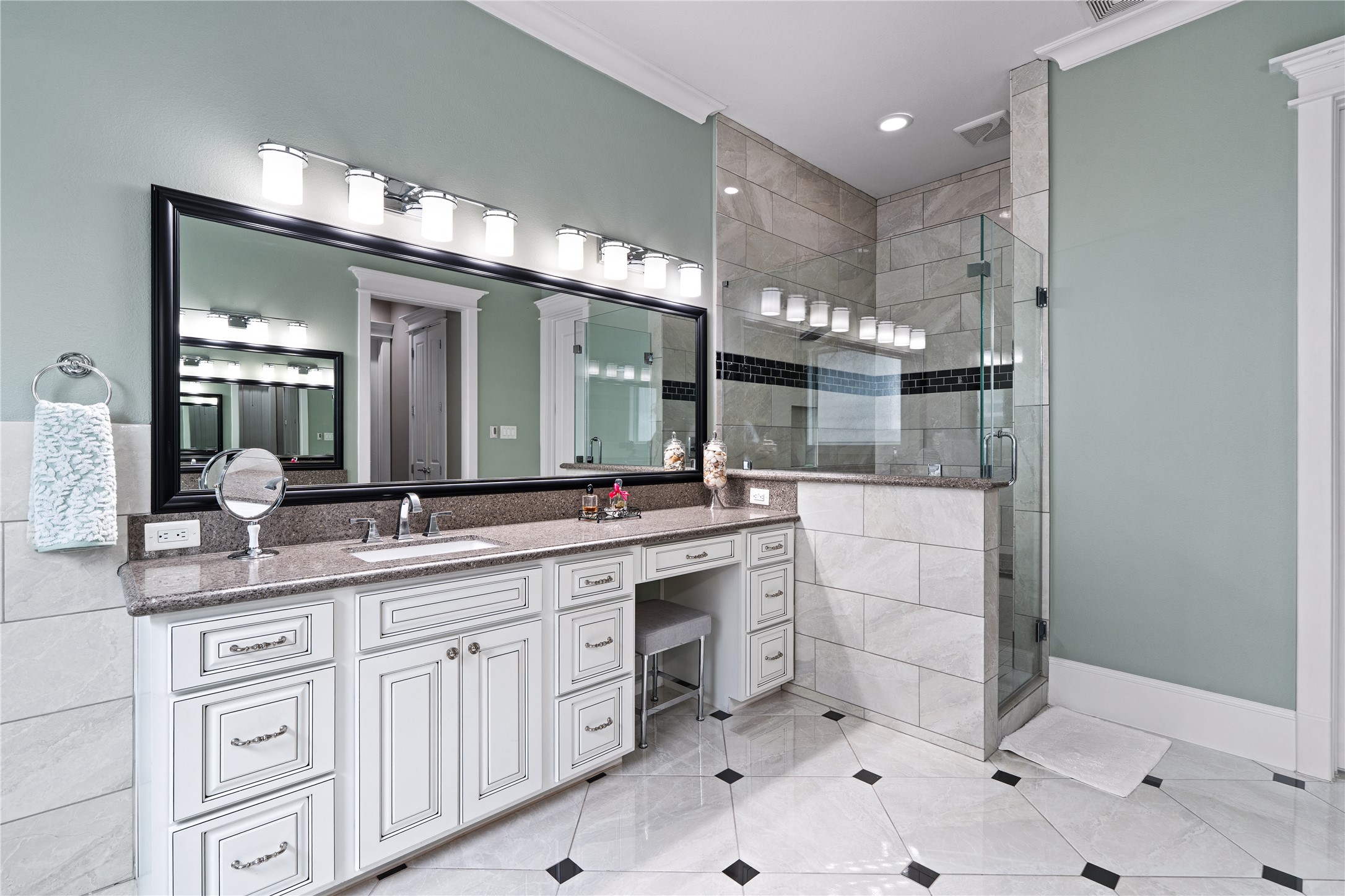 422 West 26th Street Houston, TX 77008 - Photo 23 of 39 A seamless glass enclosure leads to the walk-in shower, which is finished with updated tile-work and silver-toned hardware.
